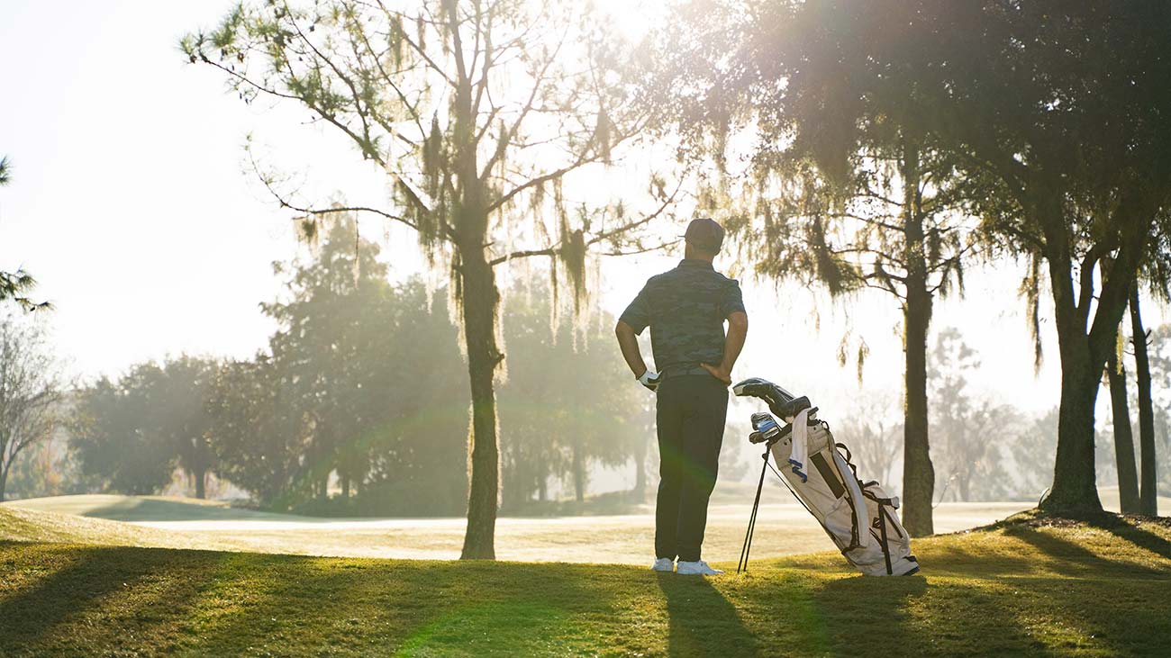 Golfer staring at the putting green